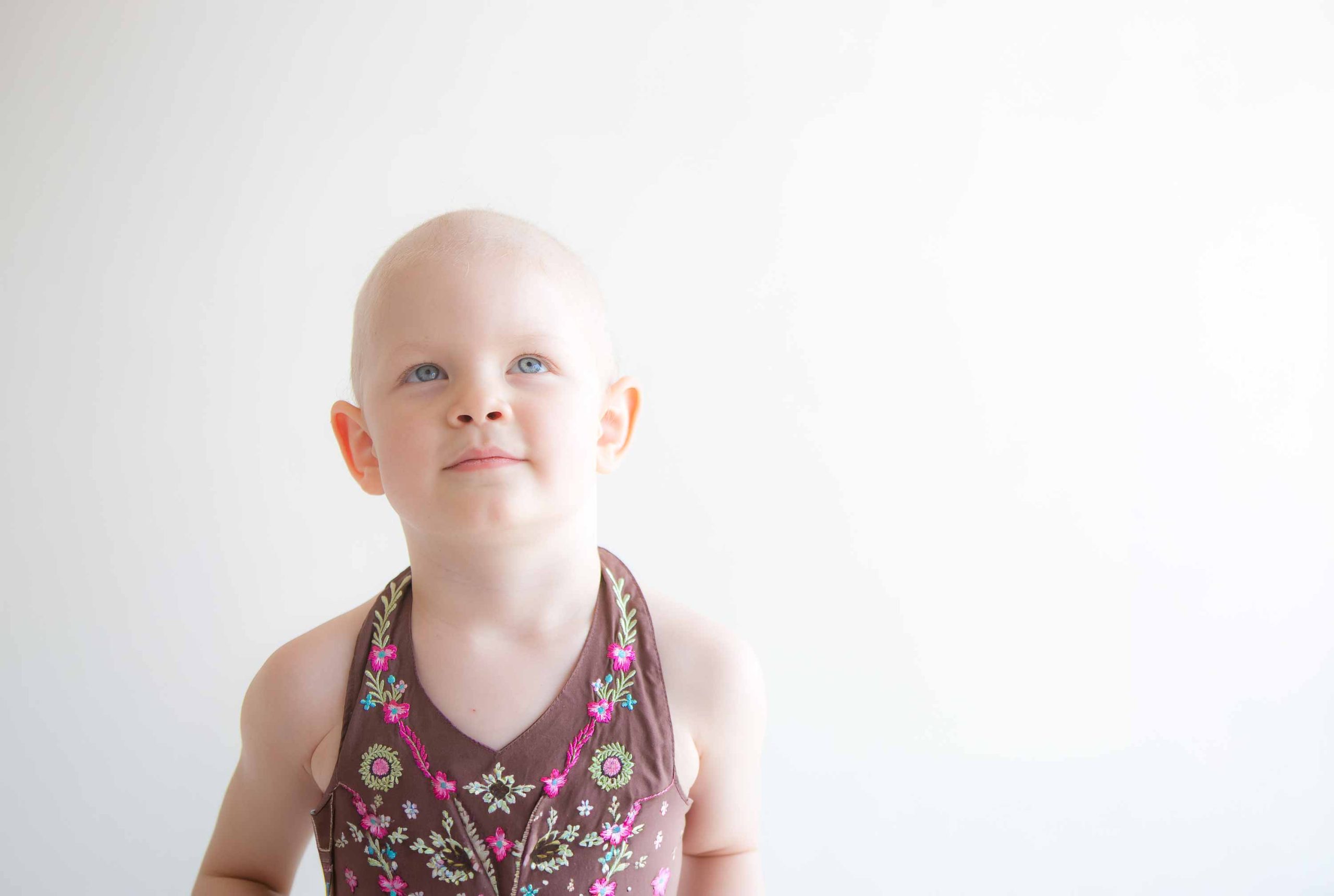 Bald child looking up